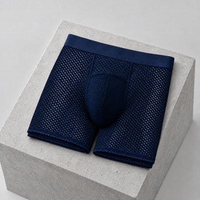 Navy men's running boxer briefs folded on a concrete block