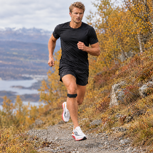 Runner on a trail wearing a patella knee strap
