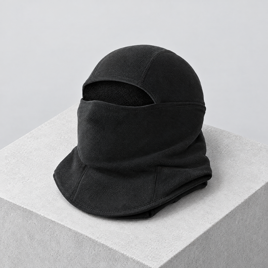 Black running balaclava folded on a concrete block